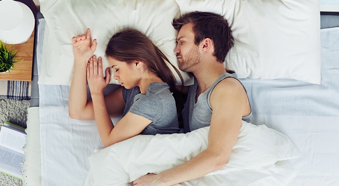 Couple sleeping in bed, Better Sleep Council